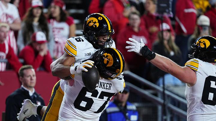 Oct 11, 2025; Madison, Wisconsin, USA; Iowa Hawkeyes running back Xavier Williams (26) celebrates a touchdown with teammate offensive lineman Gennings Dunker (67) during the second half against the Wisconsin Badgers at Camp Randall Stadium. Mandatory Credit: Ross Harried-Imagn Images