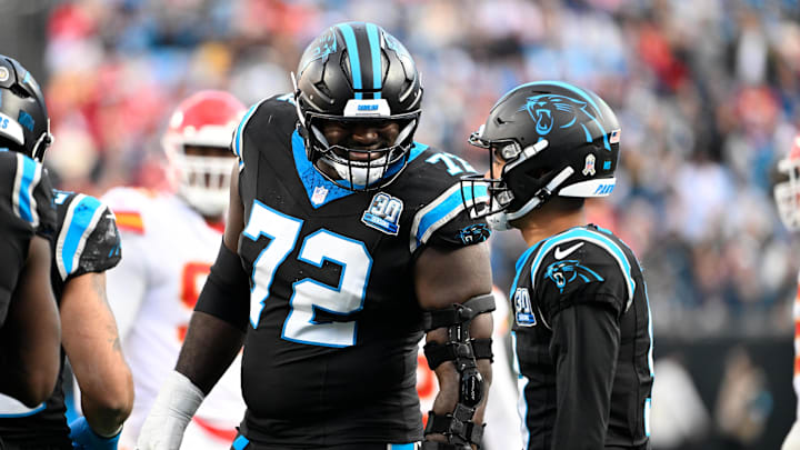 Nov 24, 2024; Charlotte, North Carolina, USA; Carolina Panthers offensive tackle Taylor Moton (72) with Carolina Panthers quarterback Bryce Young (9) in the fourth quarter at Bank of America Stadium. Mandatory Credit: Bob Donnan-Imagn Images Nov 24, 2024; Charlotte, North Carolina, USA; Carolina Panthers offensive tackle Taylor Moton (72) with Carolina Panthers quarterback Bryce Young (9) in the fourth quarter at Bank of America Stadium. Mandatory Credit: Bob Donnan-Imagn Images