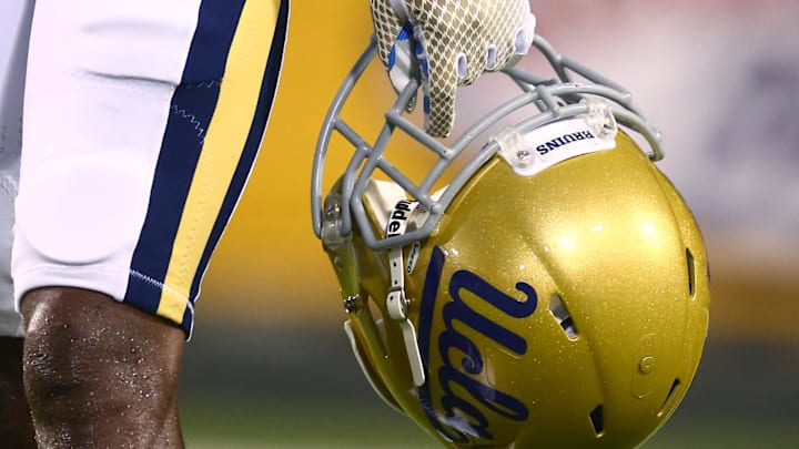 Sep 25, 2014; Tempe, AZ, USA; Detailed view of a UCLA Bruins helmet in the hand of a player against the Arizona State Sun Devils at Sun Devil Stadium. UCLA defeated Arizona State 62-27. Mandatory Credit: Mark J. Rebilas-Imagn Images