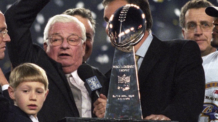 Jan 28, 2001; Tampa, FL, USA; FILE PHOTO; Baltimore Ravens owner Art Modell celebrates with the Vince Lombardi trophy after defeating the New York Giants during Super Bowl XXXV. The Ravens defeated the Giants 34-7 at Raymond James Stadium. Mandatory Credit: Imagn Images