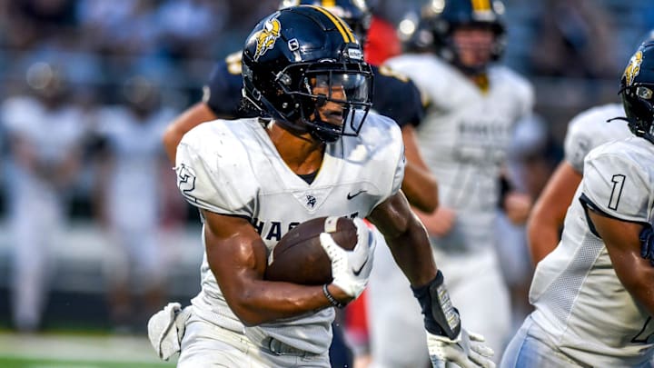 Haslett's Kory Amachree runs for a gain against DeWitt during the second quarter on Thursday, Aug. 24, 2023, at DeWitt High School. Haslett's Kory Amachree runs for a gain against DeWitt during the second quarter on Thursday, Aug. 24, 2023, at DeWitt High School.