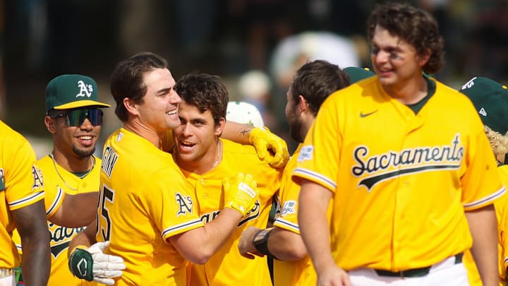Apr 18, 2026; West Sacramento, California, USA; Athletics third baseman Max Muncy (3) is mobbed by teammates as they celebrate his walk off sacrifice fly out during the 11th inning against the Chicago White Sox at Sutter Health Park. Mandatory Credit: Scott Marshall-Imagn Images