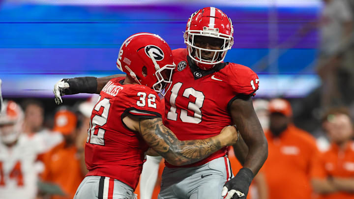 Aug 31, 2024; Atlanta, Georgia, USA; Georgia Bulldogs defensive lineman Mykel Williams (13) celebrates after a tackle with linebacker Chaz Chambliss (32) against the Clemson Tigers in the third quarter at Mercedes-Benz Stadium. Mandatory Credit: Brett Davis-Imagn Images