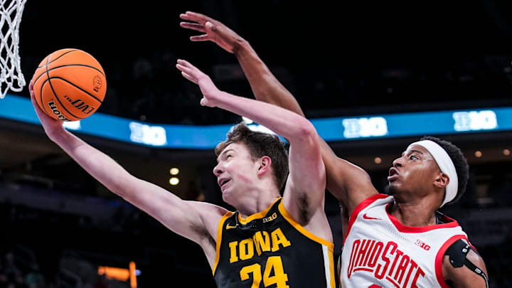 Iowa Hawkeyes forward Pryce Sandfort (24) goes up for a basket against Ohio State Buckeyes guard Micah Parrish (8) on Wednesday, March 12, 2025, in a first round game at the 2025 TIAA Big Ten Men’s Basketball Tournament between the Iowa Hawkeyes and the Ohio State Buckeyes at Gainbridge Fieldhouse in Indianapolis. The Hawkeyes defeated the Buckeyes, 77-70.