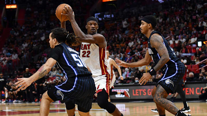 Oct 25, 2021; Miami, Florida, USA; Miami Heat forward Jimmy Butler (22) looks to pass between Orlando Magic guard Cole Anthony (50) and guard Gary Harris (14) during the second half at FTX Arena. Mandatory Credit: Jim Rassol-Imagn Images Oct 25, 2021; Miami, Florida, USA; Miami Heat forward Jimmy Butler (22) looks to pass between Orlando Magic guard Cole Anthony (50) and guard Gary Harris (14) during the second half at FTX Arena. Mandatory Credit: Jim Rassol-Imagn Images