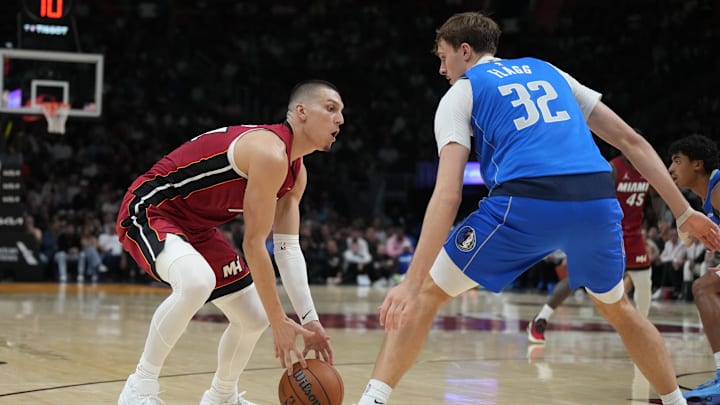 Nov 24, 2025; Miami, Florida, USA; Dallas Mavericks forward Cooper Flagg (32) defends Miami Heat guard Tyler Herro (14) during the first half at Kaseya Center. Mandatory Credit: Jim Rassol-Imagn Images
