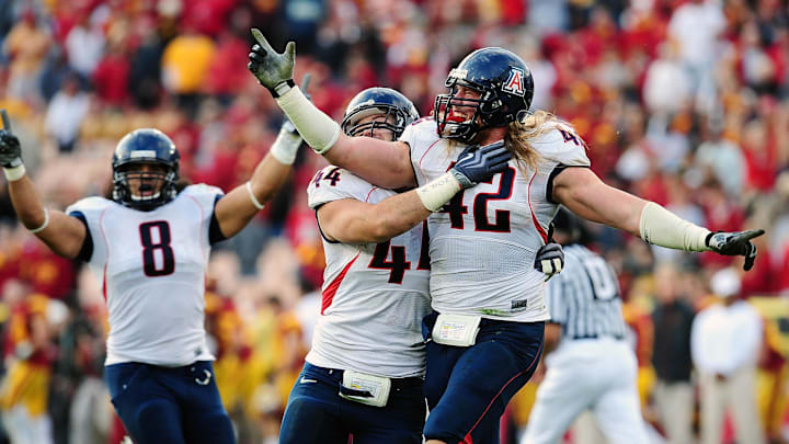 December 5, 2009; Los Angeles, CA, USA; Arizona Wildcats defensive end Brooks Reed (42), defensive end Ricky Elmore (44) and linebacker Vuna Tuihalamaka (8) celebrate after winning 21-14 against the Southern California Trojans at the Los Angeles Memorial Coliseum. Mandatory Credit: Gary A. Vasquez-Imagn Images