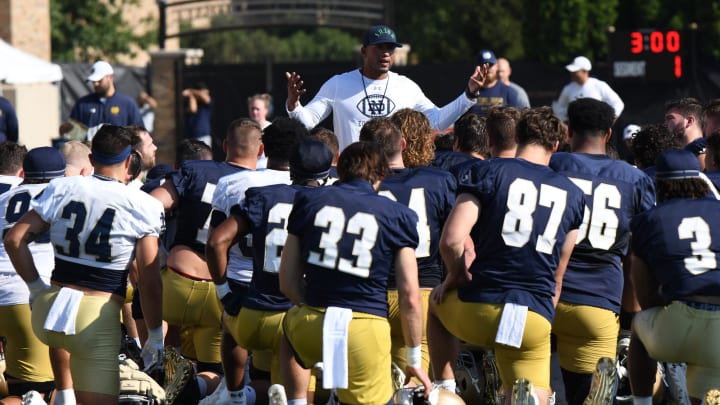 Head Coach of the Fighting Irish Marcus Freeman speaks to players after warmup at practice at the Fighting Irish Athletic Center at Notre Dame on Thursday July 27, 2023.