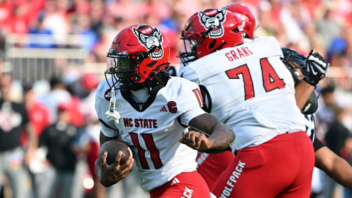 Sep 20, 2025; Durham, North Carolina, USA;  North Carolina State Wolfpack quarter back CJ Bailey (11) runs the ball against the Duke Blue Devils during the first quarter at Wallace Wade Stadium. Mandatory Credit: Zachary Taft-Imagn Images