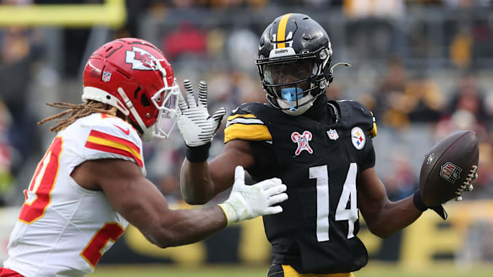 Dec 25, 2024; Pittsburgh, Pennsylvania, USA;  Pittsburgh Steelers wide receiver George Pickens (14) runs after a catch as Kansas City Chiefs safety Justin Reid (20) defends during the fourth quarter  at Acrisure Stadium. Mandatory Credit: Charles LeClaire-Imagn Images
