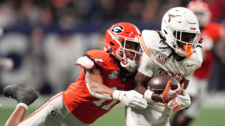 Dec 7, 2024; Atlanta, GA, USA; Texas Longhorns wide receiver Silas Bolden (11) makes a catch agaistn Georgia Bulldogs linebacker Jalon Walker (11) during the first half in the 2024 SEC Championship game at Mercedes-Benz Stadium. Mandatory Credit: Dale Zanine-Imagn Images