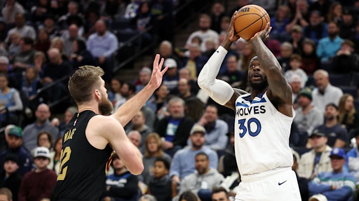 Minnesota Timberwolves forward Julius Randle shoots as Cleveland Cavaliers forward Dean Wade defends during the first quarter at Target Center in Minneapolis on Jan. 18, 2025.