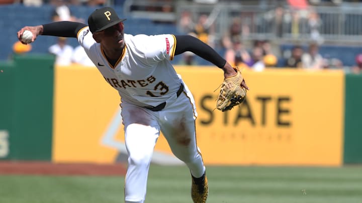 Jun 22, 2025; Pittsburgh, Pennsylvania, USA;  Pittsburgh Pirates third baseman Ke'Bryan Hayes (13) makes a bare-handed play on a ball hit for a single by Texas Rangers right fielder Adolis García during the fifth inning at PNC Park. Mandatory Credit: Charles LeClaire-Imagn Images