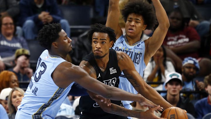Dec 13, 2024; Memphis, Tennessee, USA; Brooklyn Nets center Nic Claxton (33) handles the ball as Memphis Grizzlies forward Jaren Jackson Jr. (13) defends during the third quarter at FedExForum. Mandatory Credit: Petre Thomas-Imagn Images