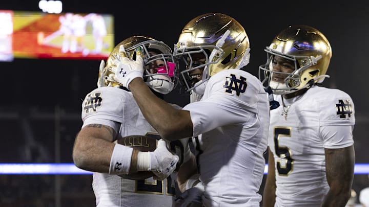 Nov 29, 2025; Stanford, California, USA;  Notre Dame Fighting Irish running back Aneyas Williams (22) celebrates with Notre Dame Fighting Irish tight end Ty Washington (7) after scoring a touchdown during the fourth quarter against the Stanford Cardinal at Stanford Stadium. Mandatory Credit: Stan Szeto-Imagn Images