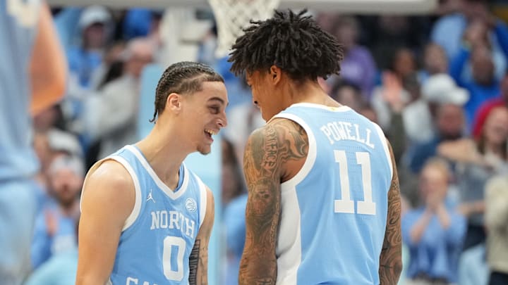 Dec 30, 2025; Chapel Hill, North Carolina, USA; North Carolina Tar Heels guard Kyan Evans (0) and forward Jonathan Powell (11) react in the second half at Dean E. Smith Center. Mandatory Credit: Bob Donnan-Imagn Images