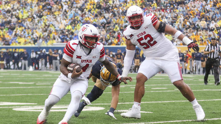 Utah Utes quarterback Devon Dampier (4) runs the ball for a touchdown during the first quarter against the West Virginia Mountaineers at Milan Puskar Stadium.