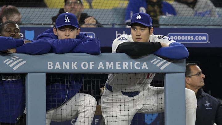 Apr 16, 2025; Los Angeles, California, USA;  Los Angeles Dodgers starting pitcher Roki Sasaki (11) and designated hitter Shohei Ohtani (17) watch from the dugout during the ninth inning against the Colorado Rockies at Dodger Stadium. Mandatory Credit: Jayne Kamin-Oncea-Imagn Images