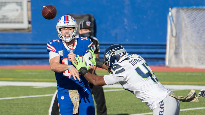 Nov 8, 2020; Orchard Park, New York, USA; Buffalo Bills quarterback Josh Allen (17) releases a pass being pressured by Seattle Seahawks defensive end Carlos Dunlap II (43) in the first quarter at Bills Stadium. Mandatory Credit: Mark Konezny-Imagn Images