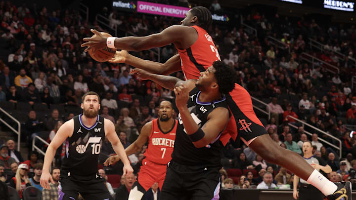 Feb 23, 2026; Houston, Texas, USA; Houston Rockets center Clint Capela (30) grabs a rebound against Utah Jazz forward Brice Sensabaugh (28)  in the third quarter at Toyota Center. Mandatory Credit: Thomas Shea-Imagn Images