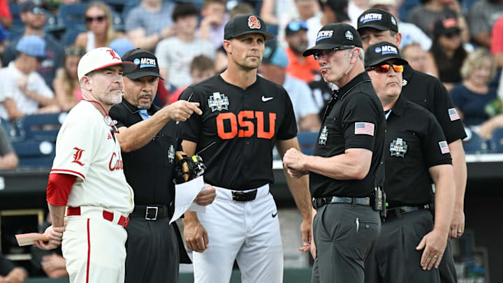 Jun 13, 2025; Omaha, Neb, USA; Louisville Cardinals head coach Dan McDonnell and Oregon State Beavers head coach Mitch Canham meet with the umpires before the game at Charles Schwab Field. Mandatory Credit: Steven Branscombe-Imagn Images