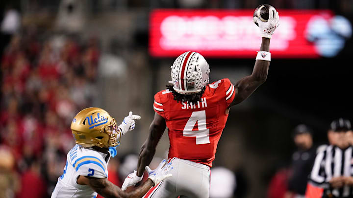 Ohio State Buckeyes wide receiver Jeremiah Smith (4) makes a one-handed catch in front of UCLA Bruins defensive back Andre Jordan Jr. (2) during the NCAA football game at Ohio Stadium in Columbus on Nov. 15, 2025.