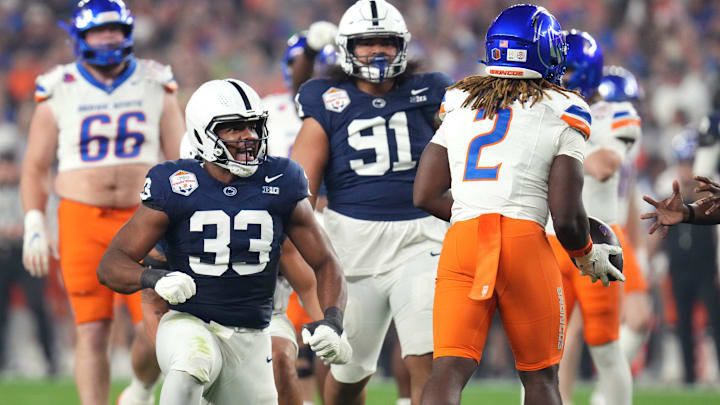 Penn State Nittany Lions defensive end Dani Dennis-Sutton (33) celebrates his tackle of Boise State Broncos running back Ashton Jeanty (2) during the Fiesta Bowl.