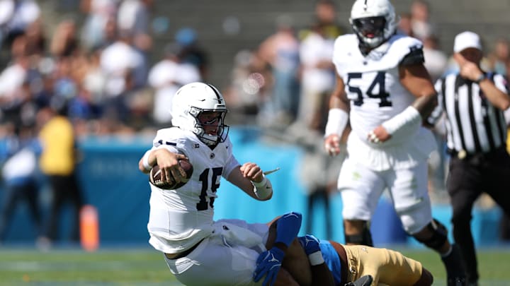 Penn State Nittany Lions quarterback Drew Allar (15) is tackled by UCLA Bruins linebacker Jonjon Vaughns (6) during the second quarter at the Rose Bowl. 