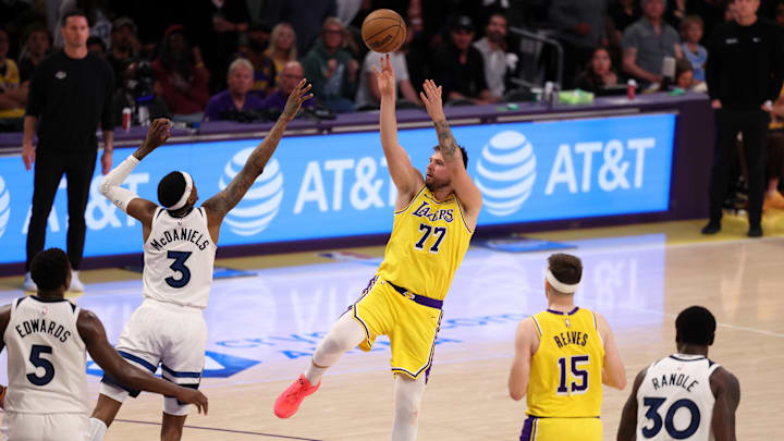 Apr 22, 2025; Los Angeles, California, USA; Los Angeles Lakers guard Luka Doncic (77) shoots the ball over Minnesota Timberwolves forward Jaden McDaniels (3) during the third quarter of game two of first round for the 2024 NBA Playoffs at Crypto.com Arena. Mandatory Credit: Kiyoshi Mio-Imagn Images