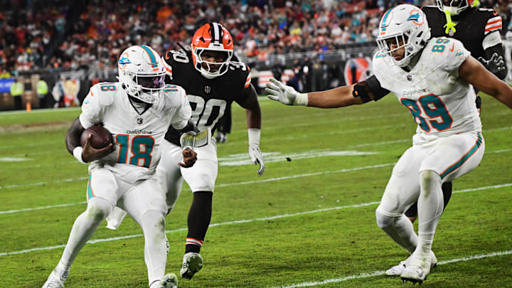 Miami Dolphins quarterback Tyler Huntley (18) scores a touchdown as Cleveland Browns linebacker Devin Bush (30) pursues during the second half at Huntington Bank Field. Miami Dolphins quarterback Tyler Huntley (18) scores a touchdown as Cleveland Browns linebacker Devin Bush (30) pursues during the second half at Huntington Bank Field.