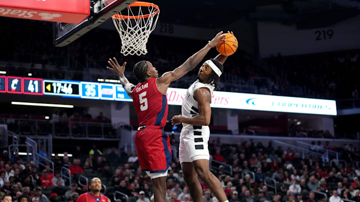 Cincinnati Bearcats guard Day Day Thomas (1) is blocked at the basket by Illinois-Chicago Flames