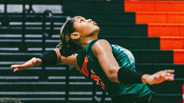 Grace Lopez spiking a ball against an opponent. Grace Lopez spiking a ball against an opponent.