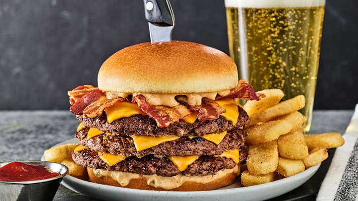 Red Robin’s new Buzzer Beater Bacon Cheeseburger, a “three-pointer” stacked high with three juicy beef patties, four strips of hardwood-smoked bacon, six slices of American cheese and dribbled with Red’s Secret Tavern Sauce™ and served with a bottomless side. Available for dine-in or to go from March 3 through April 7. Order on redrobin.com or the Red Robin mobile app.