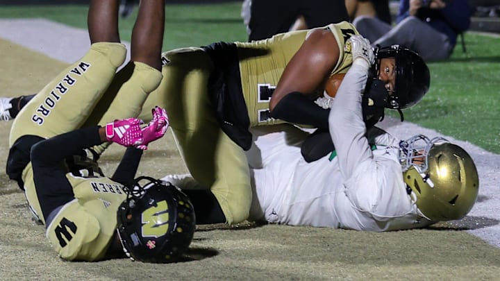 Cathedral Evan Johnson (88) attempts without success to break away the football from Warren Central Jerimy Finch Jr. (11