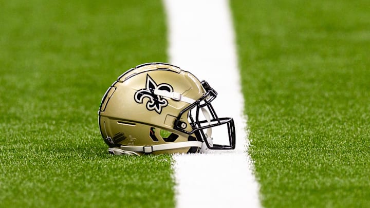 Aug 25, 2024; New Orleans, Louisiana, USA;  New Orleans Saints helmet on the turf during warmups before the game against the Tennessee Titans at Caesars Superdome. Mandatory Credit: Stephen Lew-Imagn Images