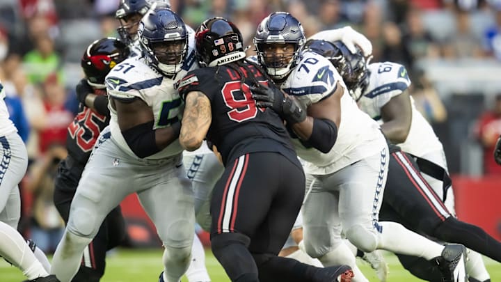 Dec 8, 2024; Glendale, Arizona, USA; Seattle Seahawks center Olu Oluwatimi (51) and guard Laken Tomlinson (70) against Arizona Cardinals defensive tackle Roy Lopez (98) at State Farm Stadium. Dec 8, 2024; Glendale, Arizona, USA; Seattle Seahawks center Olu Oluwatimi (51) and guard Laken Tomlinson (70) against Arizona Cardinals defensive tackle Roy Lopez (98) at State Farm Stadium.
