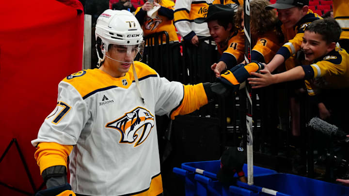 Mar 25, 2025; Raleigh, North Carolina, USA;  Nashville Predators right wing Luke Evangelista (77) goes past the fans on his way to the ice for the the warmups before the game against the Carolina Hurricanes at Lenovo Center. Mandatory Credit: James Guillory-Imagn Images