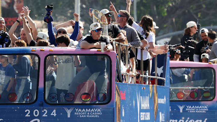 Nov 1, 2024; Los Angeles, CA, USA;  Los Angeles Dodgers manager Dave Roberts celebrates with the Commissioner’s Trophy during the 2024 World Series Championship parade in downtown Los Angeles.  Mandatory Credit: Kiyoshi Mio-Imagn Images