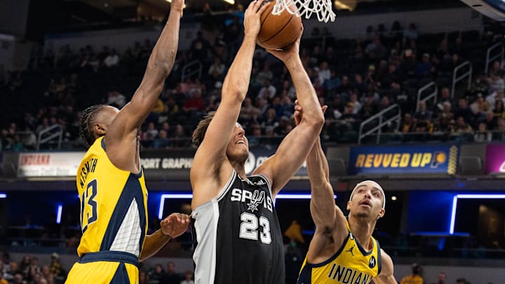 Oct 21, 2022; Indianapolis, Indiana, USA; San Antonio Spurs forward Zach Collins (23) shoots the ball while Indiana Pacers forward Aaron Nesmith (23) and guard Andrew Nembhard (2) defend in the first half at Gainbridge Fieldhouse. Mandatory Credit: Trevor Ruszkowski-Imagn Images Oct 21, 2022; Indianapolis, Indiana, USA; San Antonio Spurs forward Zach Collins (23) shoots the ball while Indiana Pacers forward Aaron Nesmith (23) and guard Andrew Nembhard (2) defend in the first half at Gainbridge Fieldhouse. Mandatory Credit: Trevor Ruszkowski-Imagn Images