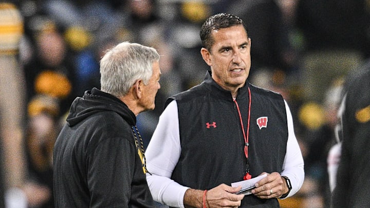 Nov 2, 2024; Iowa City, Iowa, USA; Iowa Hawkeyes head coach Kirk Ferentz (left) and Wisconsin Badgers head coach Luke Fickell (right) talk before the game at Kinnick Stadium. Mandatory Credit: Jeffrey Becker-Imagn Images