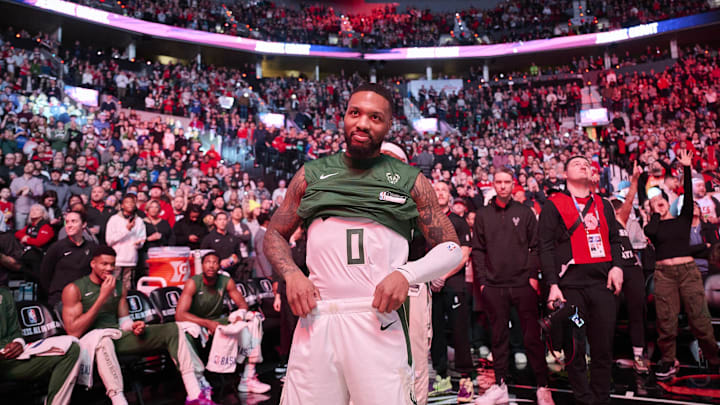 Jan 31, 2024; Portland, Oregon, USA; Milwaukee Bucks guard Damian Lillard (0) listens as fans applaud his return before a game against the Portland Trail Blazers at Moda Center. Mandatory Credit: Troy Wayrynen-Imagn Images