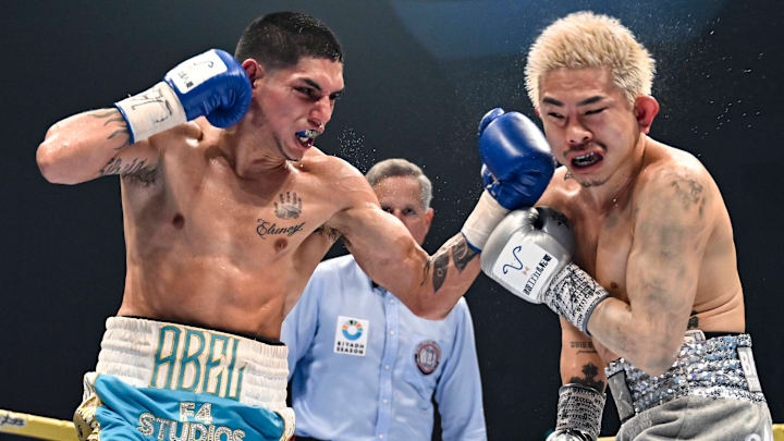 Fernando Martinez (left) hits Kazuto Ioka (right) with a powerful left uppercut.
