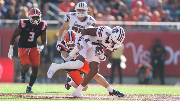 Dec 31, 2024; Orlando, FL, USA; South Carolina Gamecocks running back Dylan Stewart (6) runs the ball against Illinois Fighting Illini linebacker James Kreutz (41) in the first quarter at Camping World Stadium. Mandatory Credit: Jeremy Reper-Imagn Images