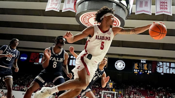 Dec 29, 2025; Tuscaloosa, AL, USA; Alabama forward Amari Allen (5) snags a ball on the baseline in front of Yale forward Isaac Celiscar (8) and Yale guard Devon Arlington (44) at Coleman Coliseum. Mandatory Credit: Gary Cosby Jr.-Tuscaloosa News