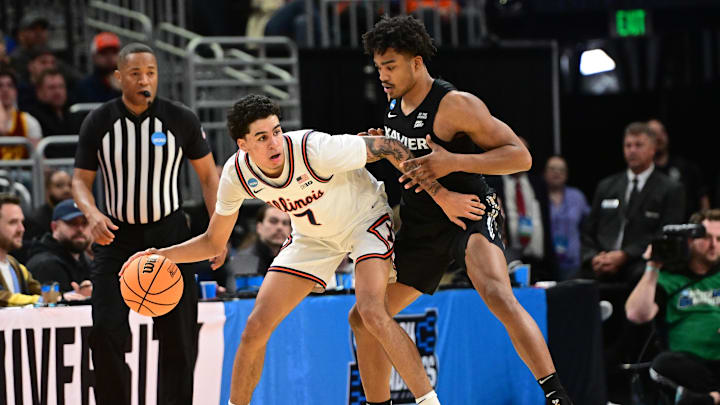 Mar 21, 2025; Milwaukee, WI, USA: Illinois Fighting Illini forward Will Riley (7) drives to the hoop past Xavier Musketeers guard Marcus Foster (1) during the first half at Fiserv Forum. Mandatory Credit: Benny Sieu-Imagn Images