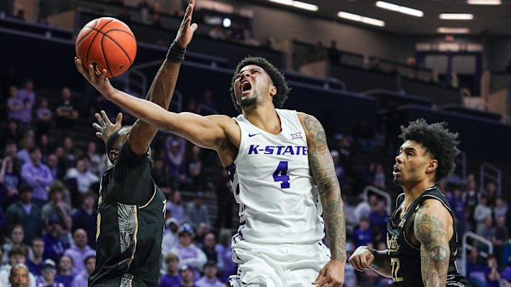 Kansas State guard PJ Haggerty (4) shoots against UCF forward Devan Cambridge (left) and guard Chris Johnson during the second half at Bramlage Coliseum. 