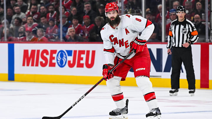 Apr 16, 2025; Montreal, Quebec, CAN; Carolina Hurricanes defenseman Brent Burns (8) considers his options with the puck against the Montreal Canadiens in the second period at Bell Centre. Mandatory Credit: David Kirouac-Imagn Images