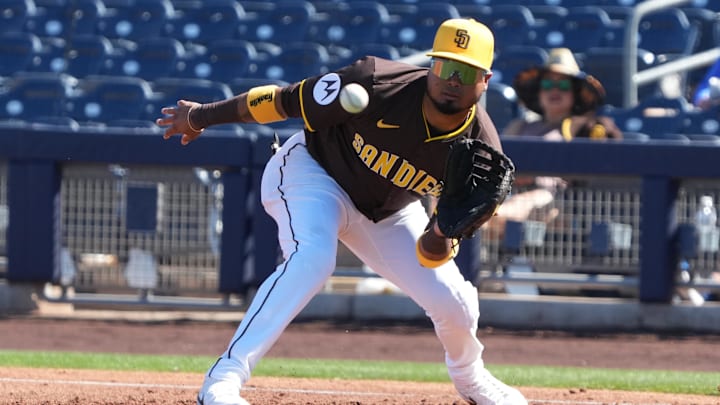 Feb 25, 2025; Peoria, Arizona, USA; San Diego Padres first baseman Luis Arraez (4) makes a play for an out against the Los Angeles Angels during the third inning at Peoria Sports Complex. Mandatory Credit: Rick Scuteri-Imagn Images