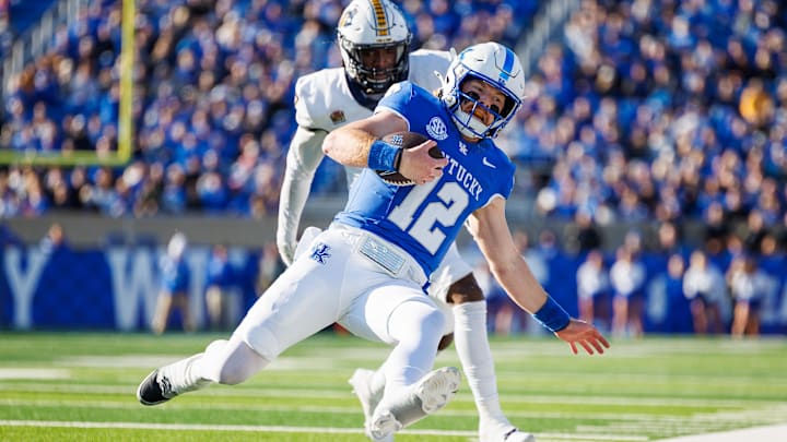 Nov 16, 2024; Lexington, Kentucky, USA; Kentucky Wildcats quarterback Brock Vandagriff (12) is forced out of bounds by Murray State Racers linebacker Justice Cross (7) during the second quarter at Kroger Field. Mandatory Credit: Jordan Prather-Imagn Images