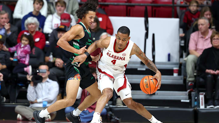 Nov 3, 2025; Tuscaloosa, Alabama, USA; Alabama Crimson Tide guard Davion Hannah (4) drives to the basket guarded by North Dakota Fighting Hawks guard Anthony Smith III (9) during the second half at Coleman Coliseum. Mandatory Credit: David Leong-Imagn Images
